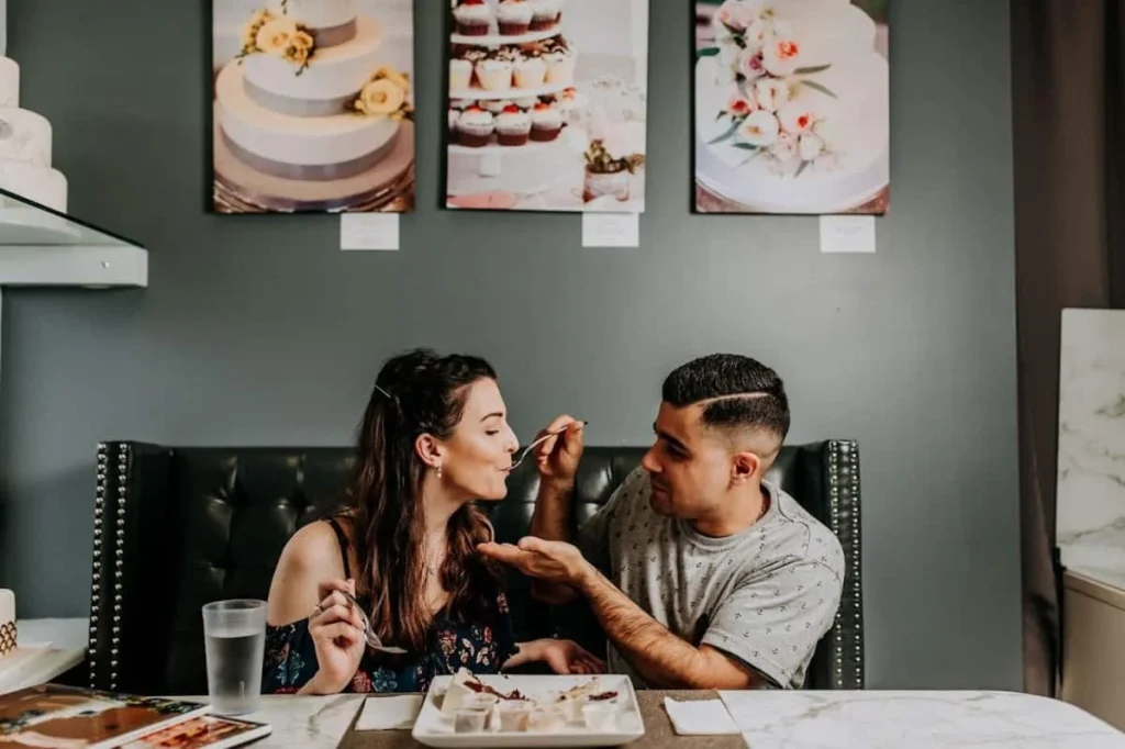 Engaged couple enjoying wedding cake tasting at Sweet Fiesta Cakes in Utah