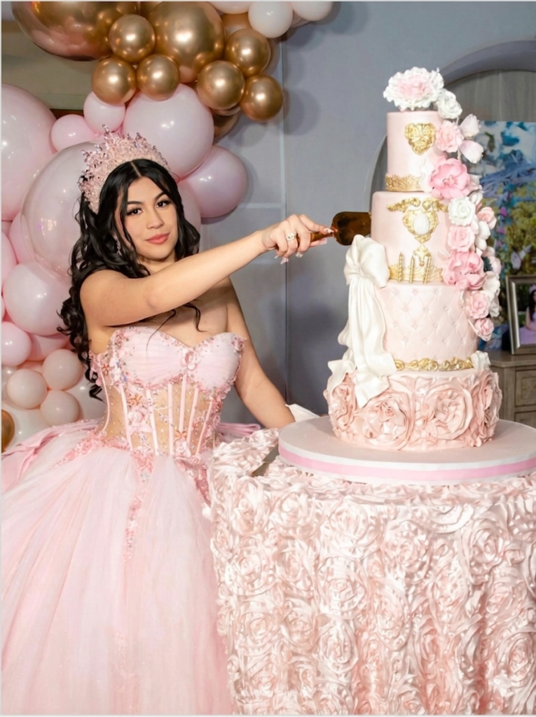quinceañera cake cutting moment with birthday girl in pink ball gown and crown at her quince celebration